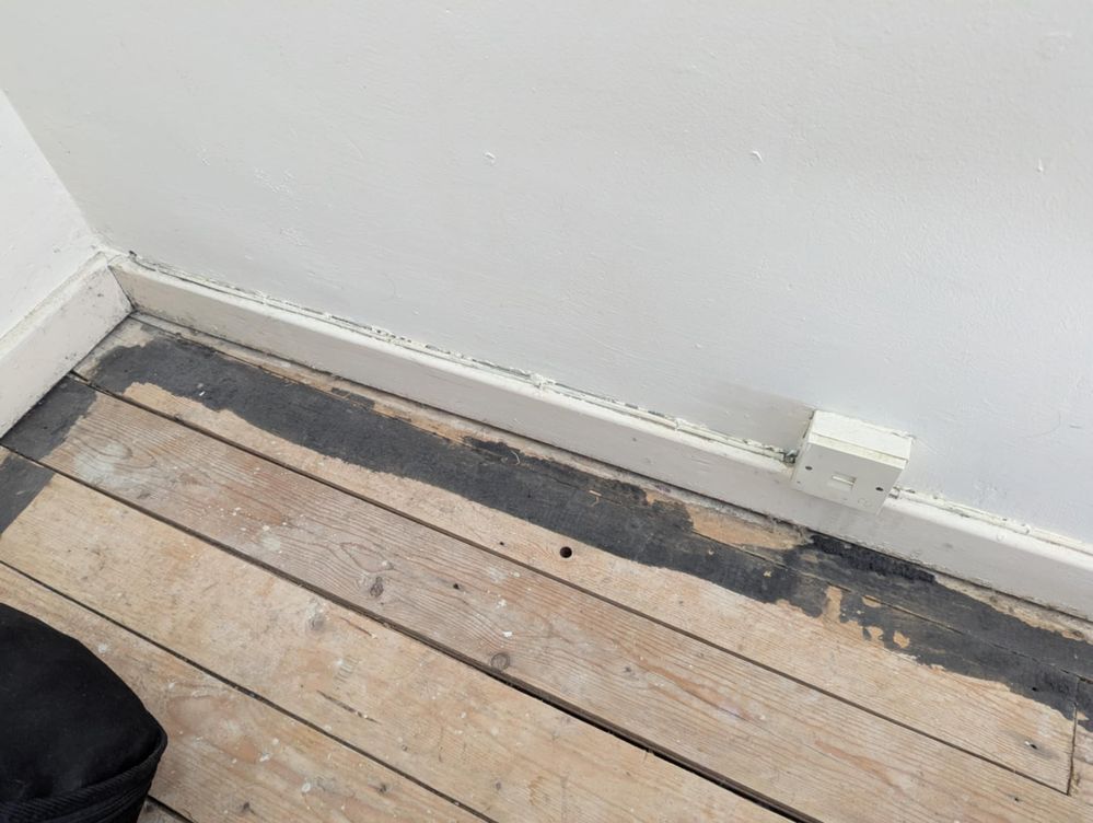 The office socket with the wire running into the corner